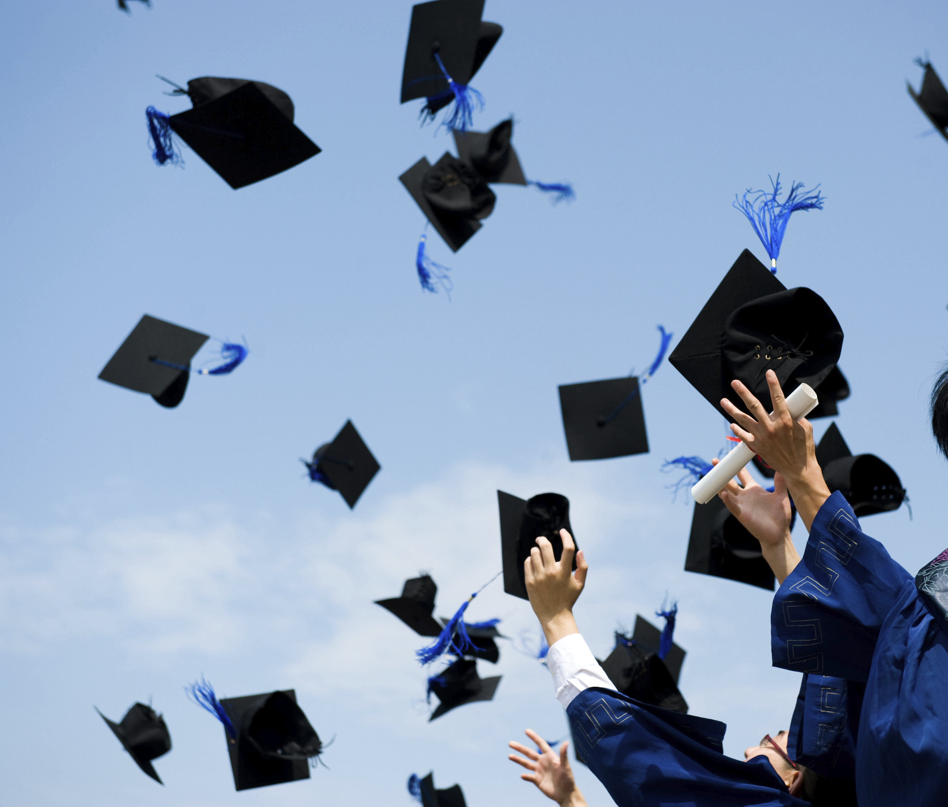 graduation caps thrown in air